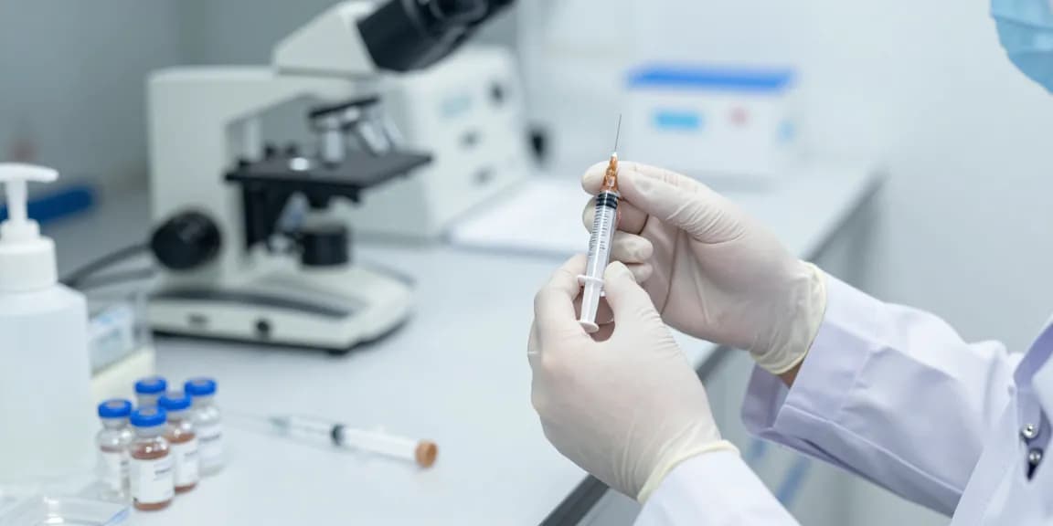 Luer lock syringe preparation in a sterile lab by a healthcare professional.